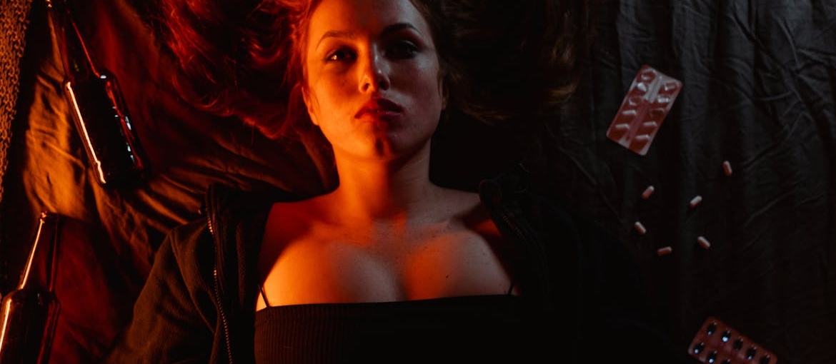 A girl in bed worrying about the difference between MDMA and Ecstasy.