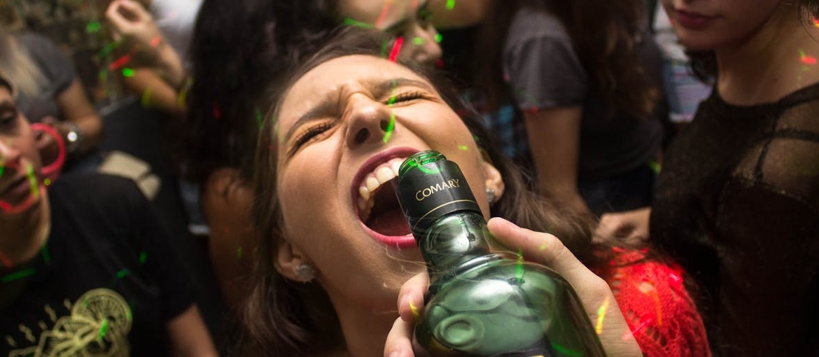 A woman heavy drinking at a party