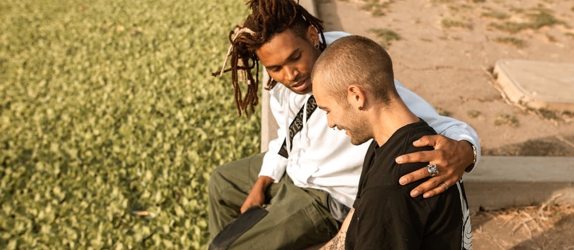 Two male friends hugging.