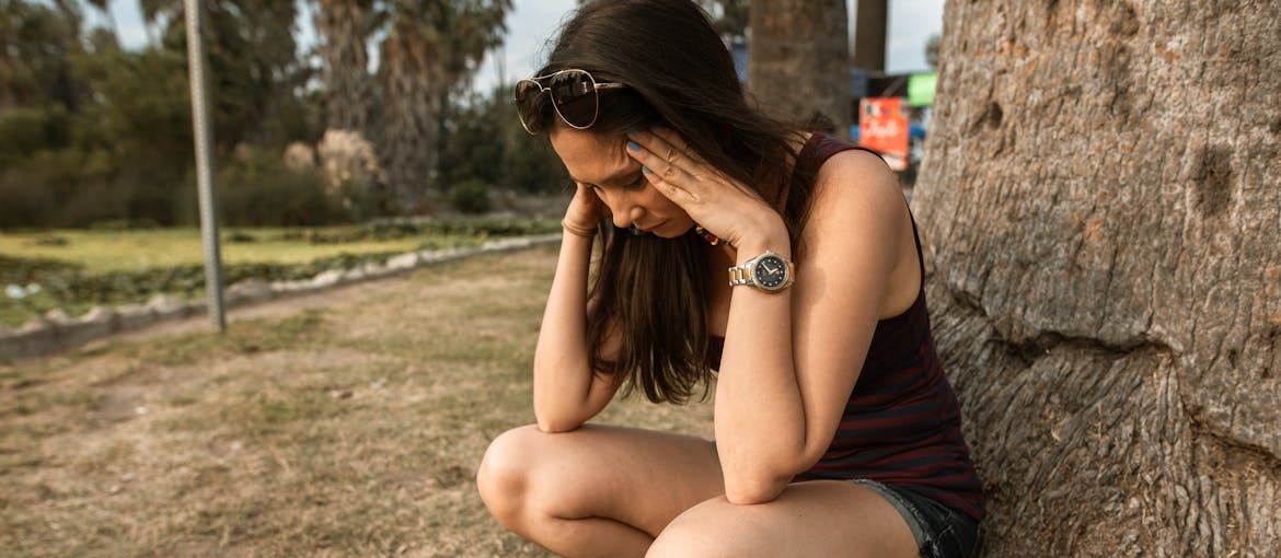 Woman experiencing anxiety as one of Ritalin side effects in females.
