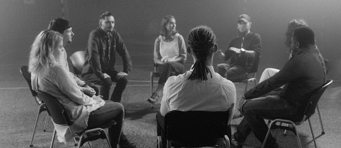 People attending group therapy for addiction.