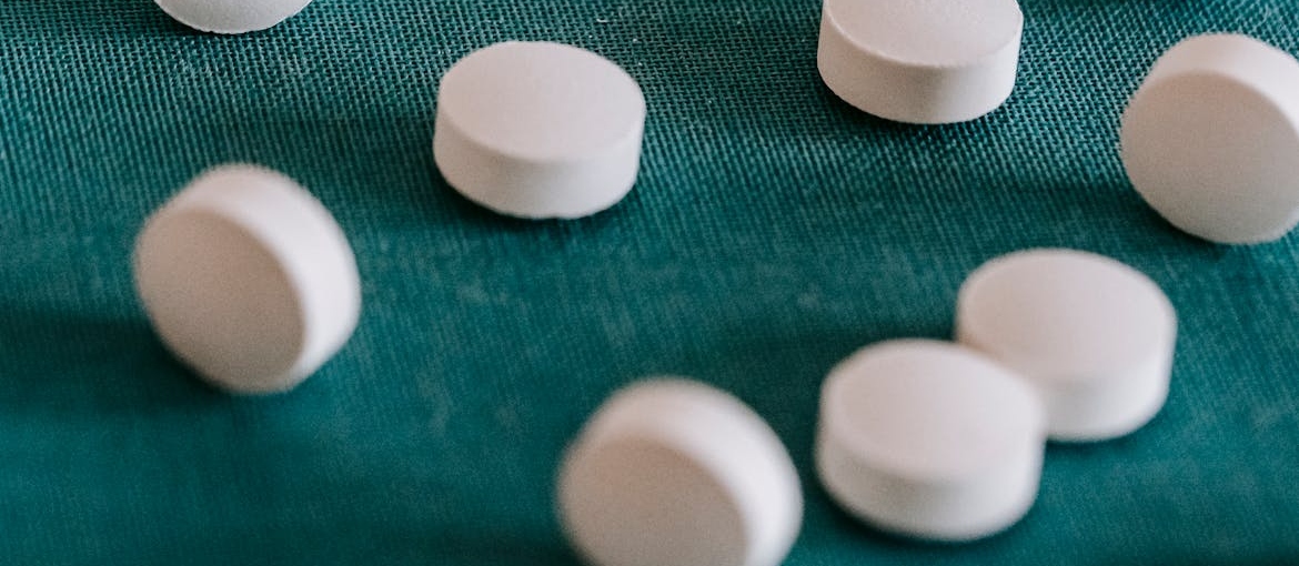 White pills on a blue background.