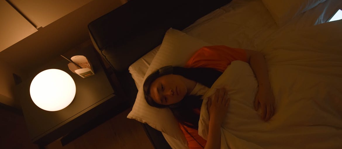 Woman lying in bed awake.