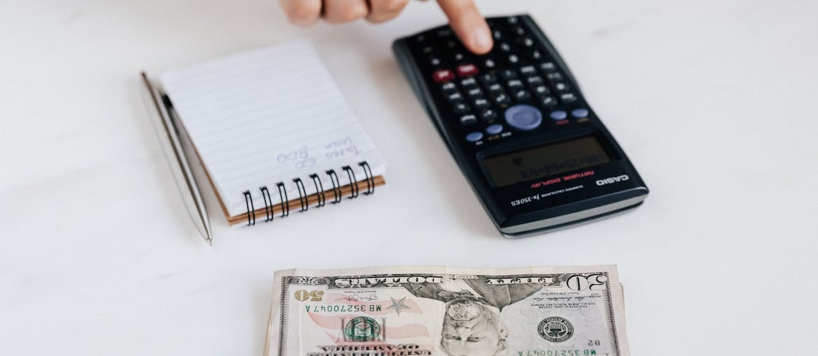 Person calculating financial benefits of a sober lifestyle.