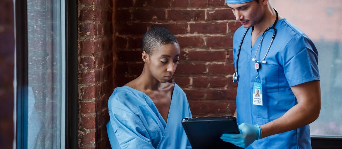 A doctor is showing his patient her diagnosis.