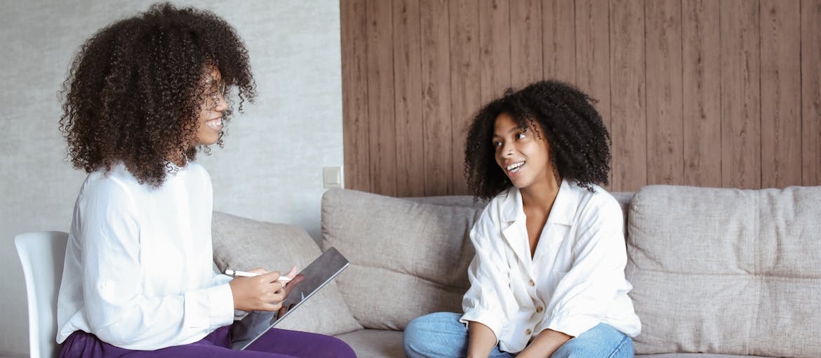 Woman talking to her therapist about her struggles with eating disorders and addiction.