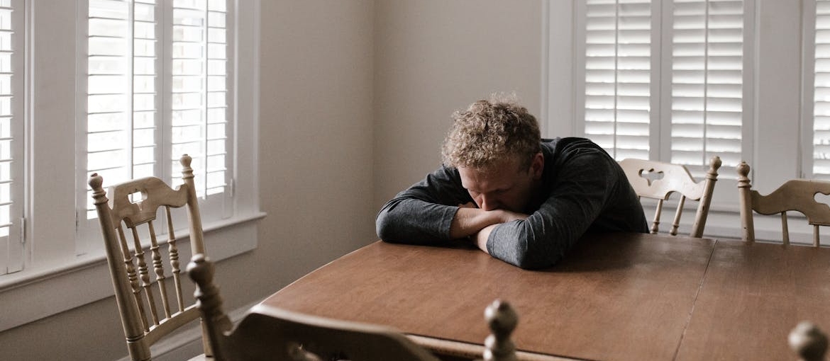 Man having a migraine while experiencing his struggle with quitting marijuana addiction.