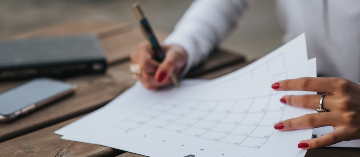 Woman creating a calendar after learning what recovery looks like when you have ADHD.