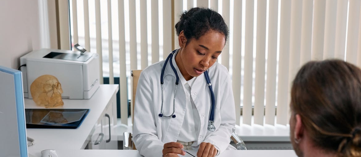Doctor adjusting a substance abuse relapse prevention plan while talking to her patient.