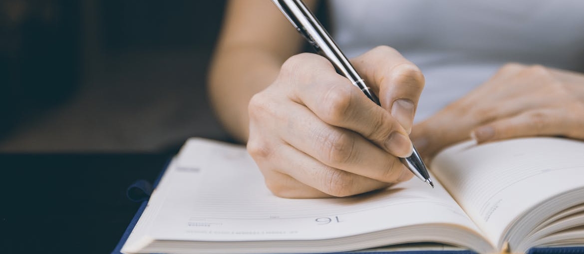 Woman writing in a notebook.