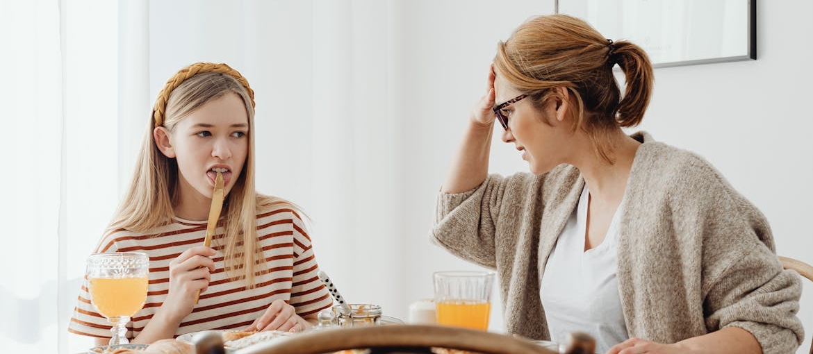 Woman having breakfast with her daughter.