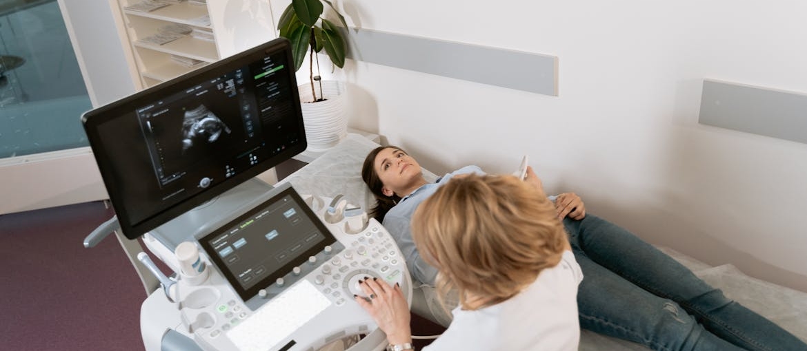 Doctor doing an ultrasound on her pregnant patient.