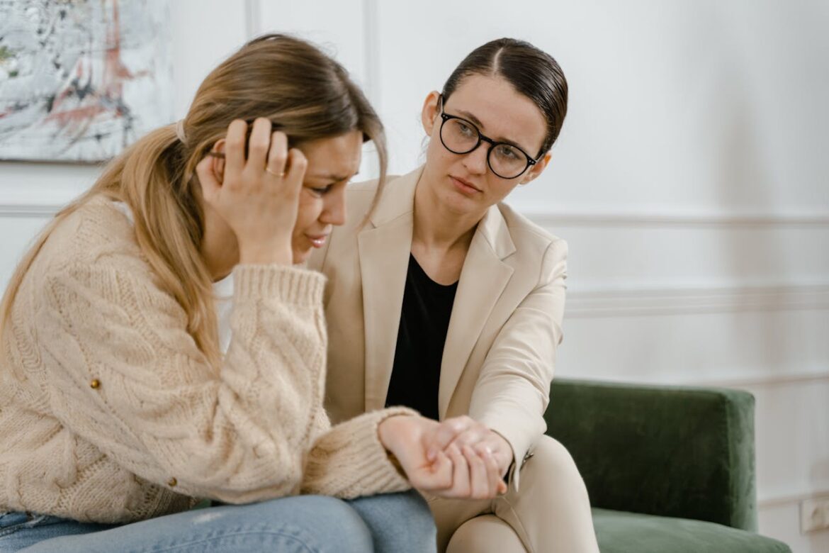 Woman comforting her crying friend.