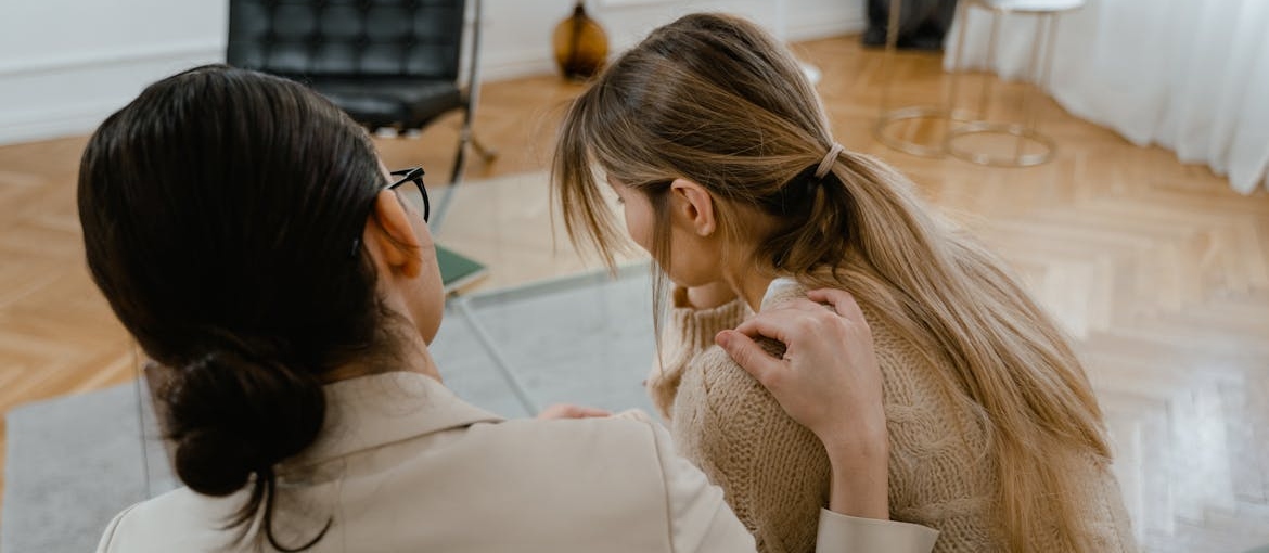 Woman comforting her friend after a relapse.