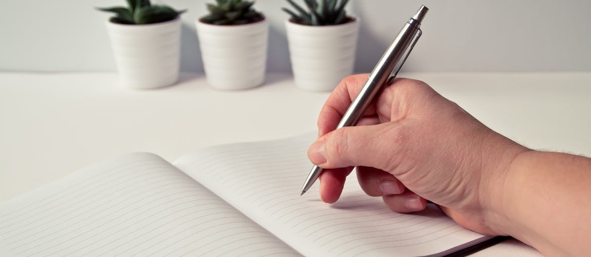Person writing down useful coping skills in recovery.