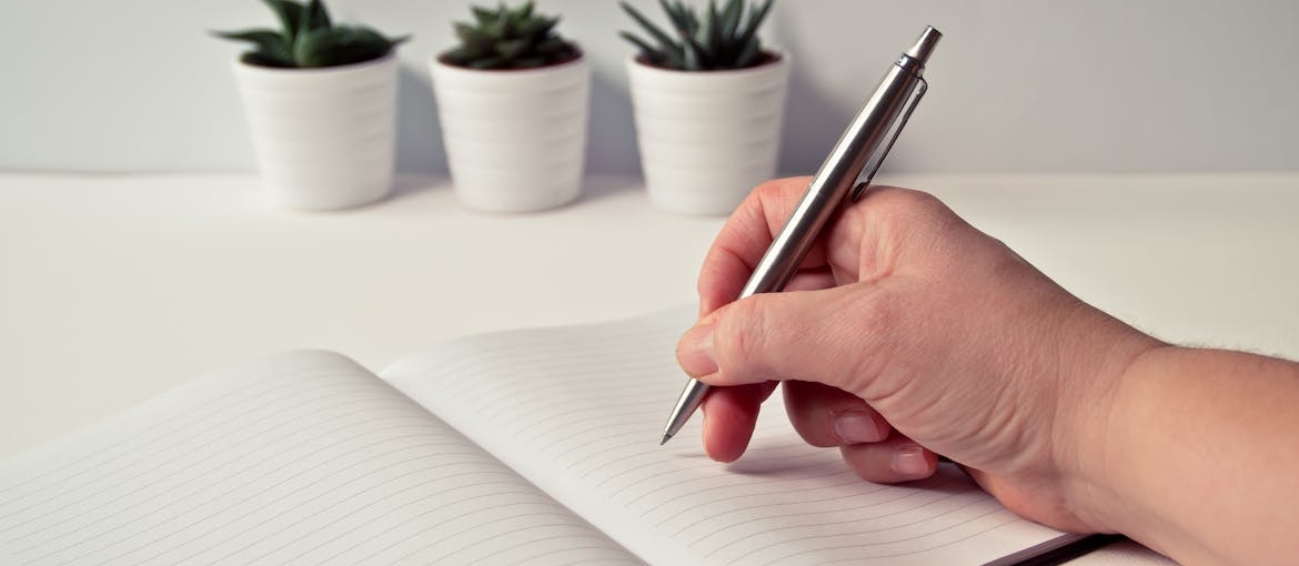 Person their substance abuse relapse prevention plan in a notebook.
