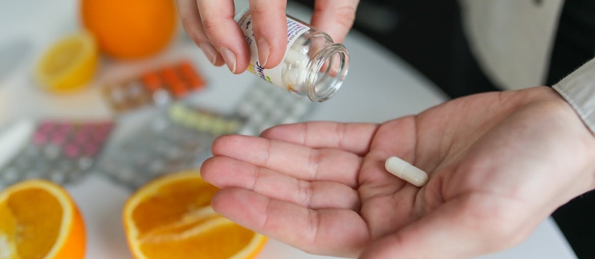 Person taking a pill after learning what recovery looks like when you have ADHD.