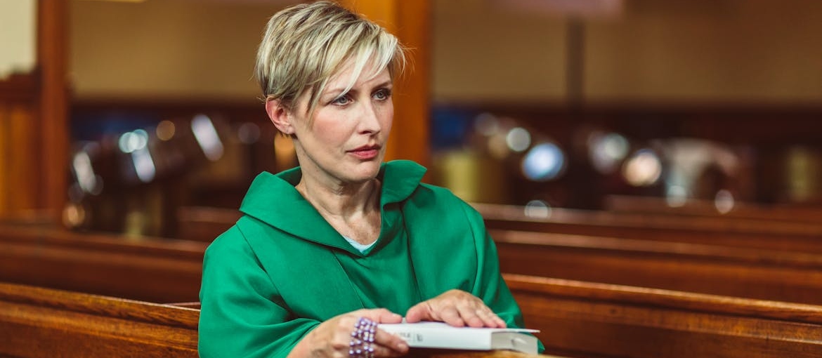 Woman attending church and holding a bible.