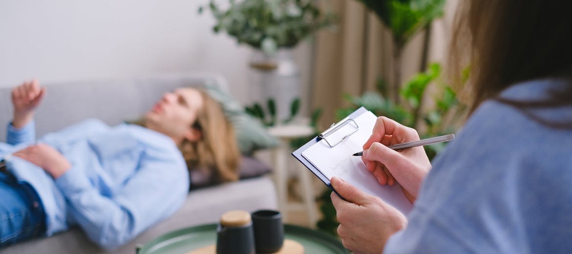 Man talking about alcohol use disorder during alcohol awareness month with his therapist.
