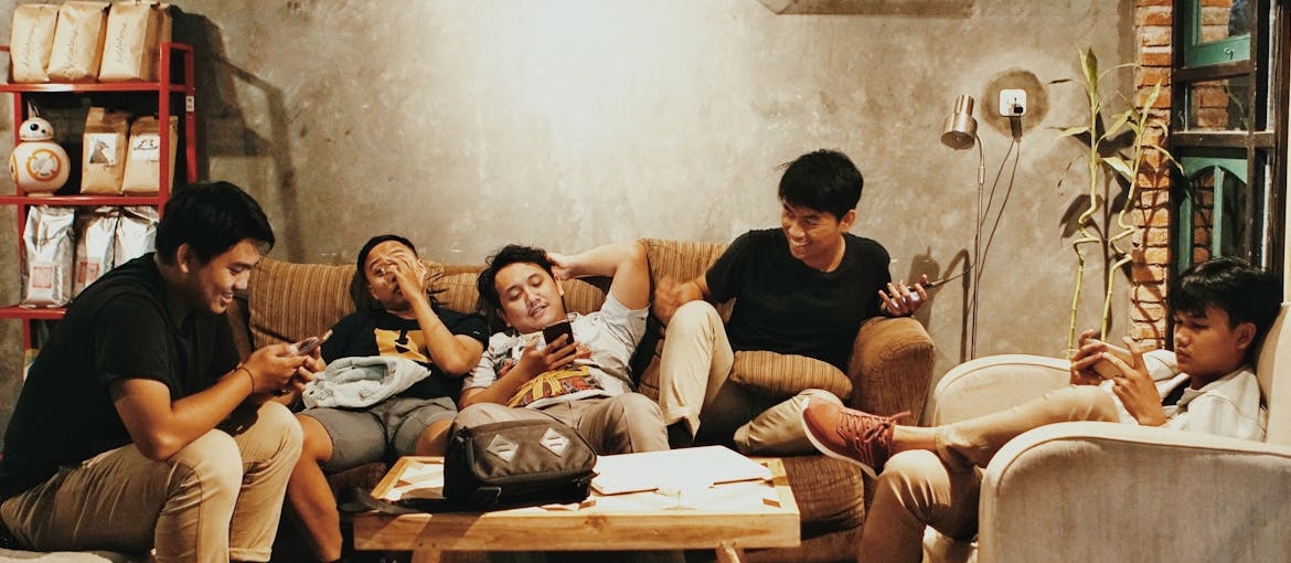 Friends sitting in a living room and hanging out.