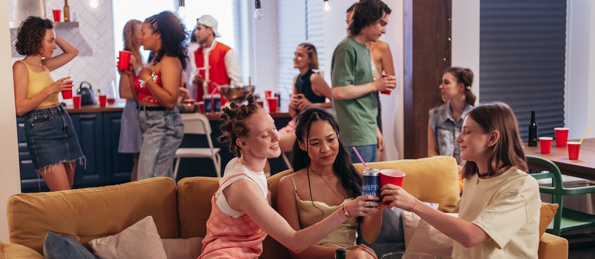 People having fun and drinking at a college party.