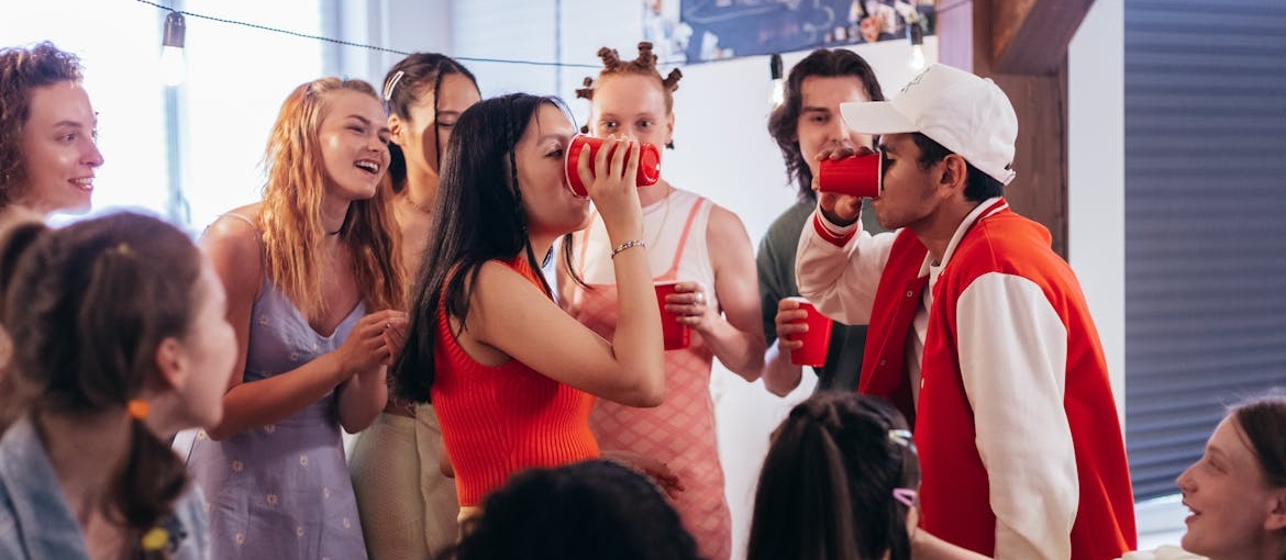 People having fun and drinking at a college party.