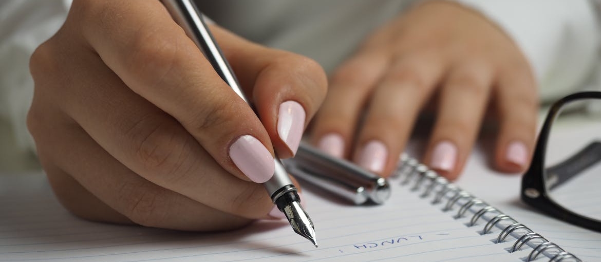 Woman making a list in her notebook.