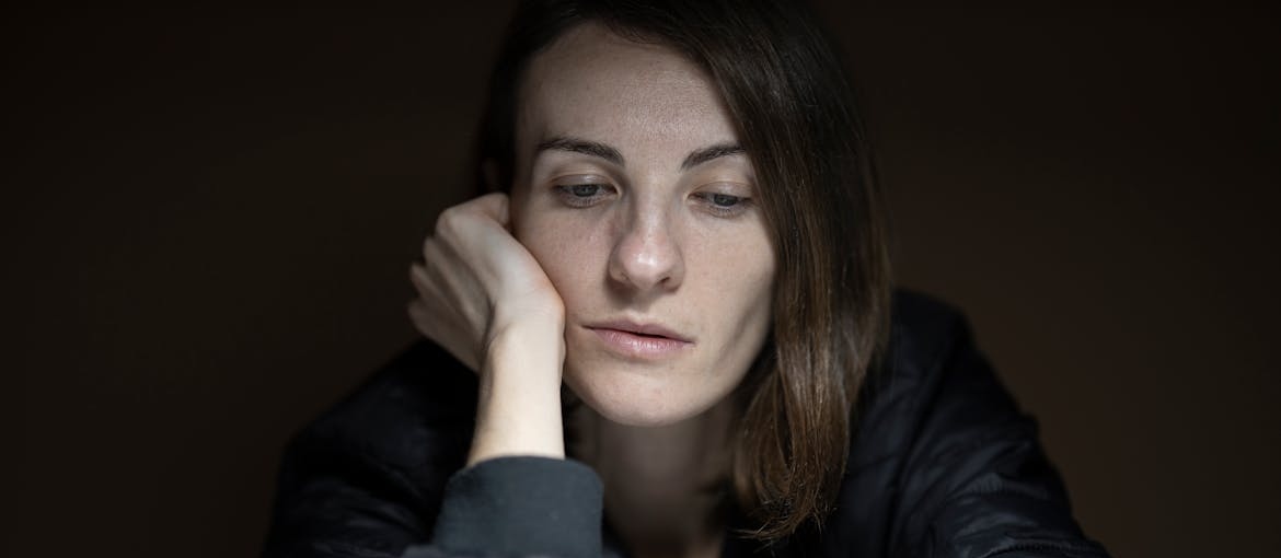 Woman thinking about addictive personality vs stress.
