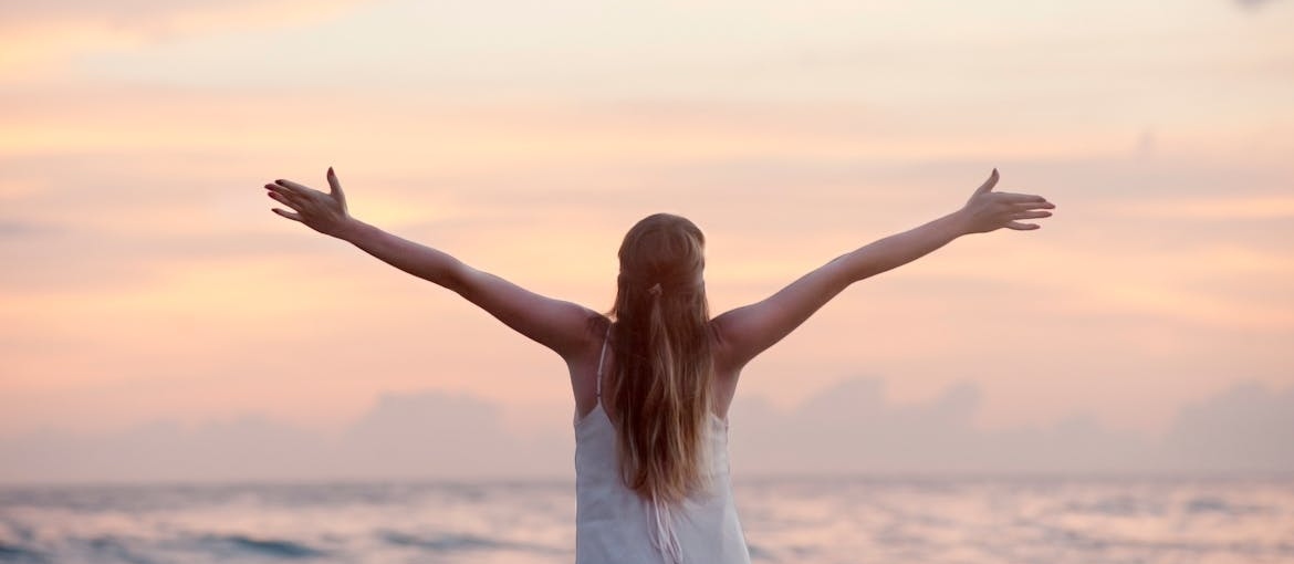 Woman raising her arms towards the sky.