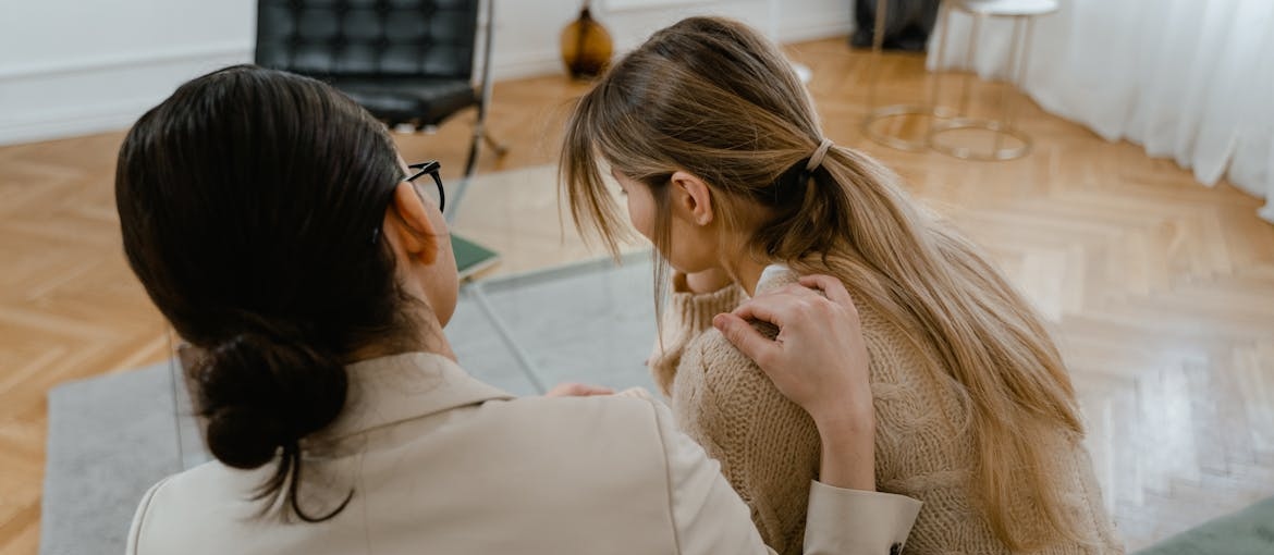 Woman supporting a young student struggling with navigating college life in recovery.