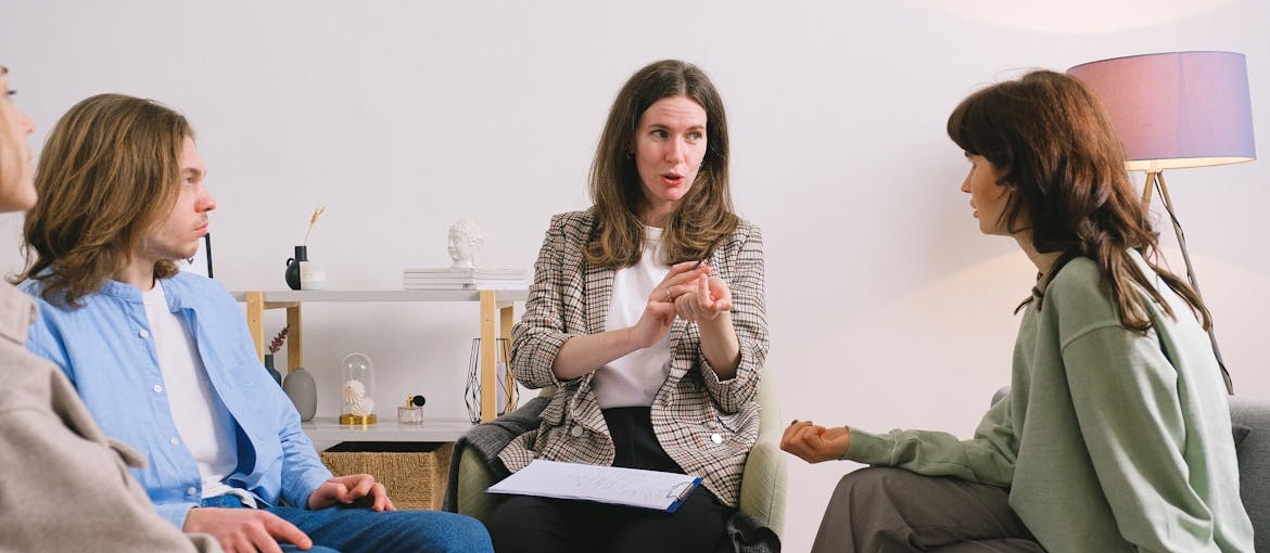 People in group therapy discuss being neurodivergent addiction recovery.