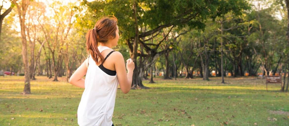 Woman running in the park as her long-term sobriety support.