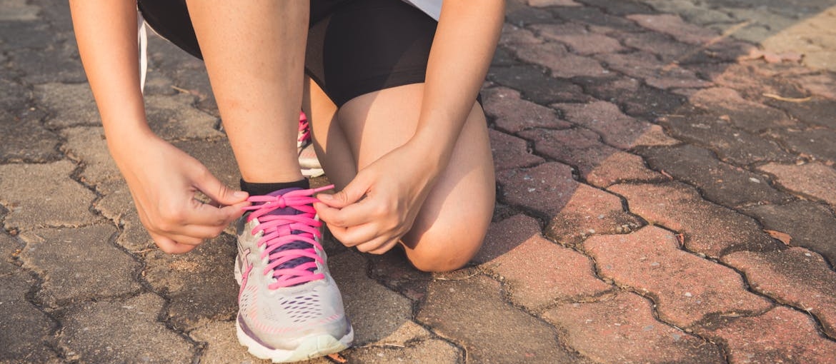 Woman tying her shoelaces.