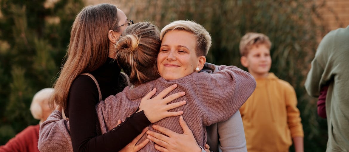 Family members hugging each other.