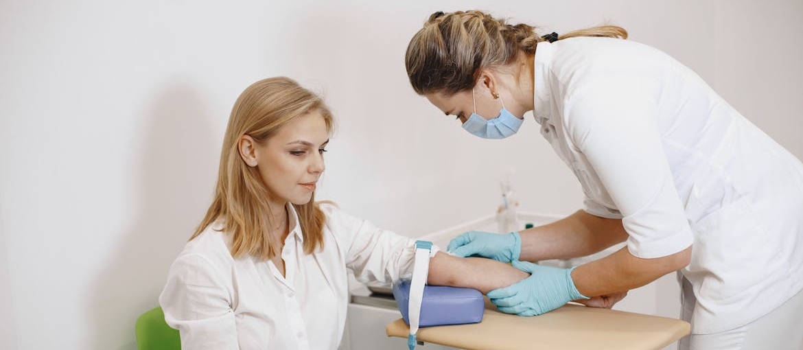 Woman getting her blood drawn by a nurse.