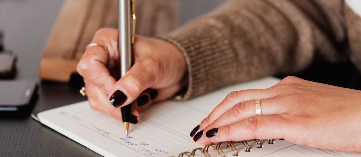 Woman writing in a journal.