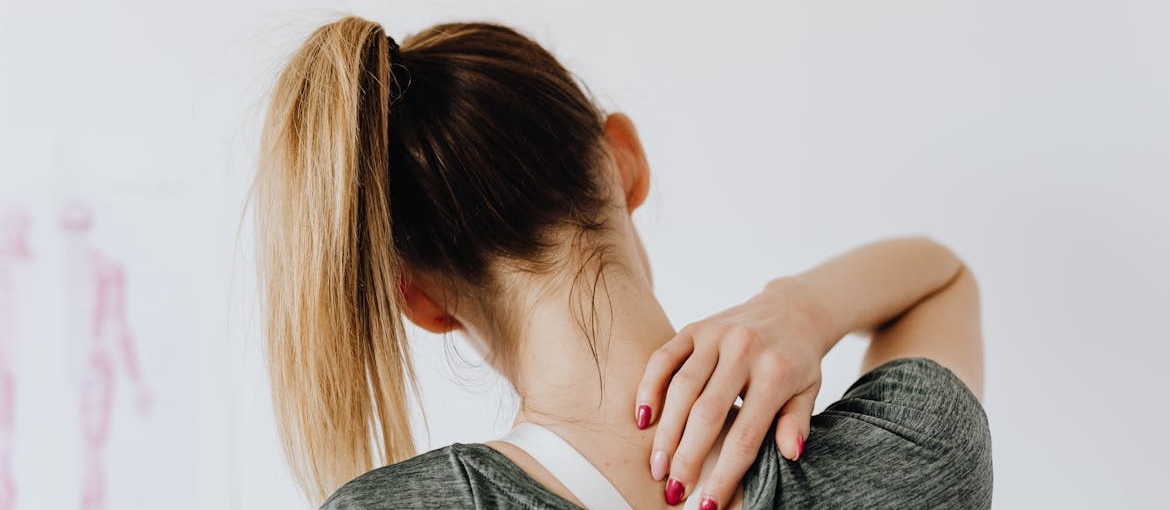 Woman suffering from back and neck pain during withdrawal.