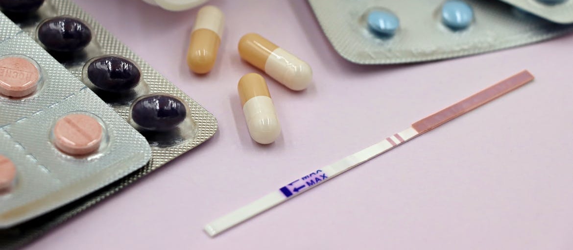 Strip test next to blisters of pills.