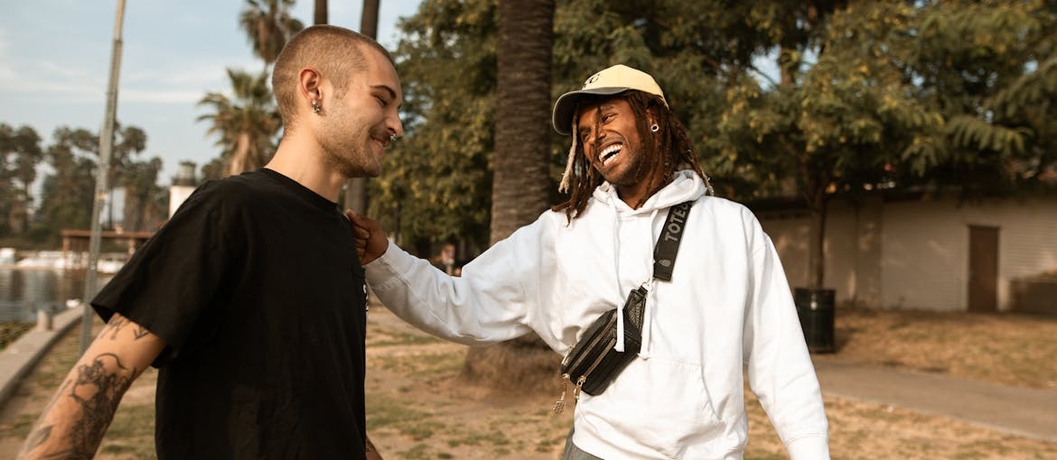Two men laughing and talking with each other.