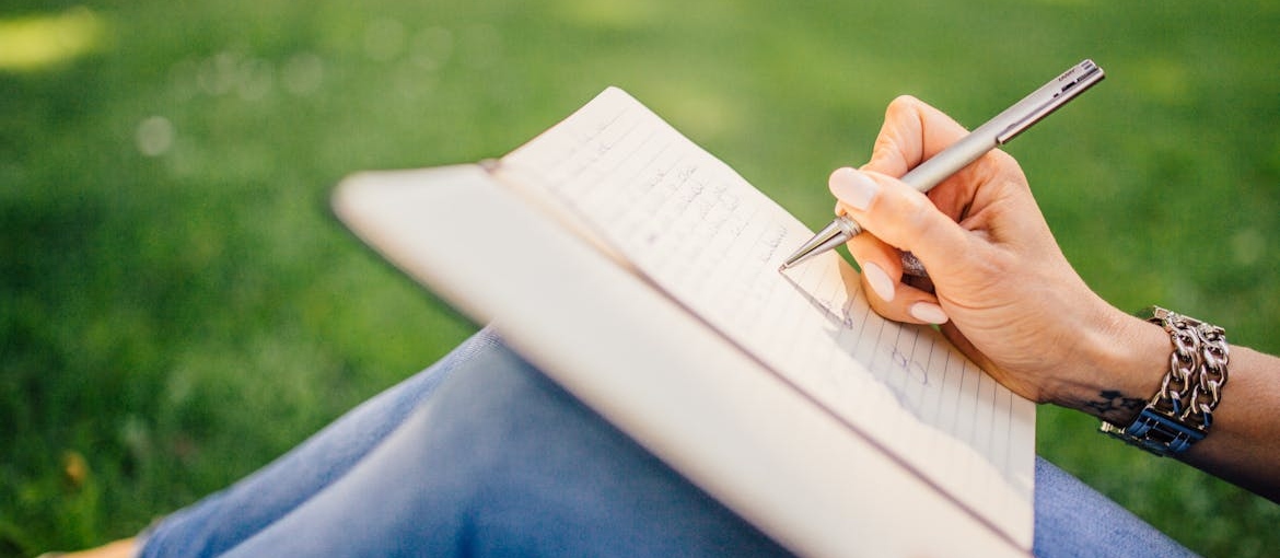Woman journaling about masking trauma with humor.