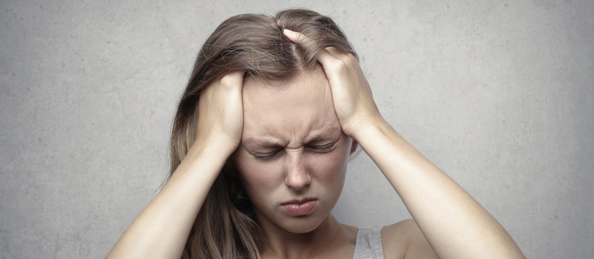Woman having a headache because of trazodone withdrawal.