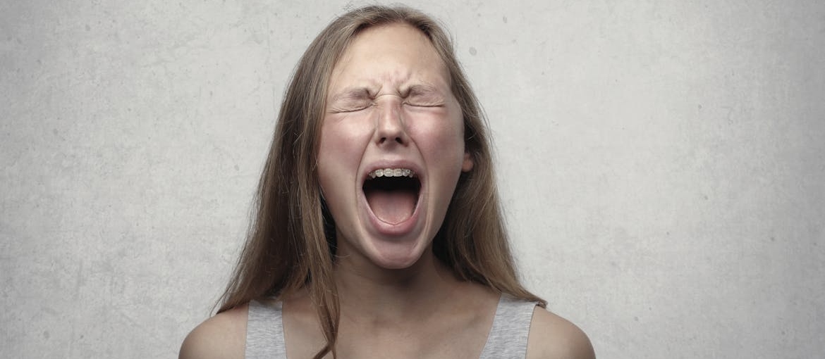 Young woman screaming.