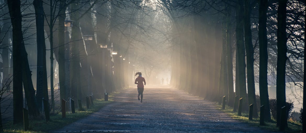 Woman running in a park.
