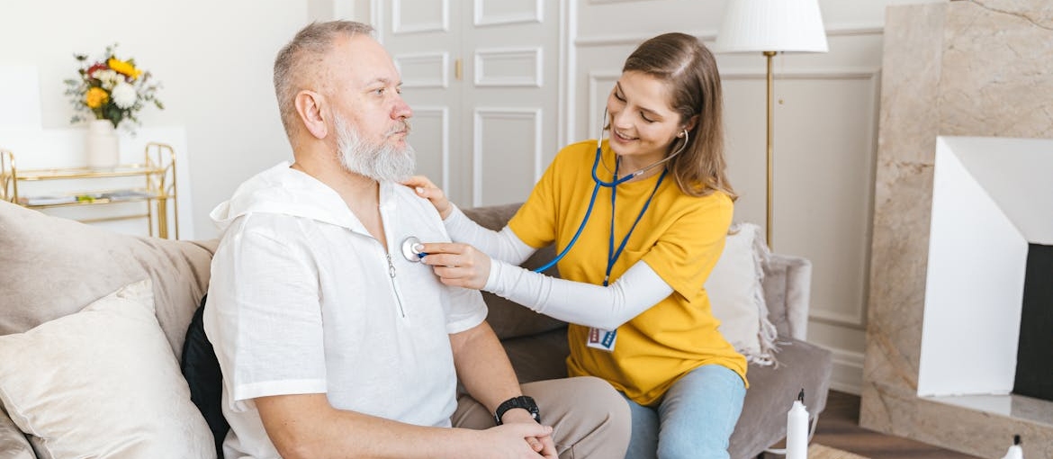 Older man getting his health checkup during senior addiction treatment.