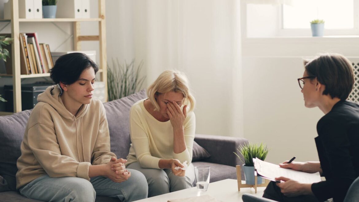 Mother talking about the struggle of being parents of addicts in family therapy.