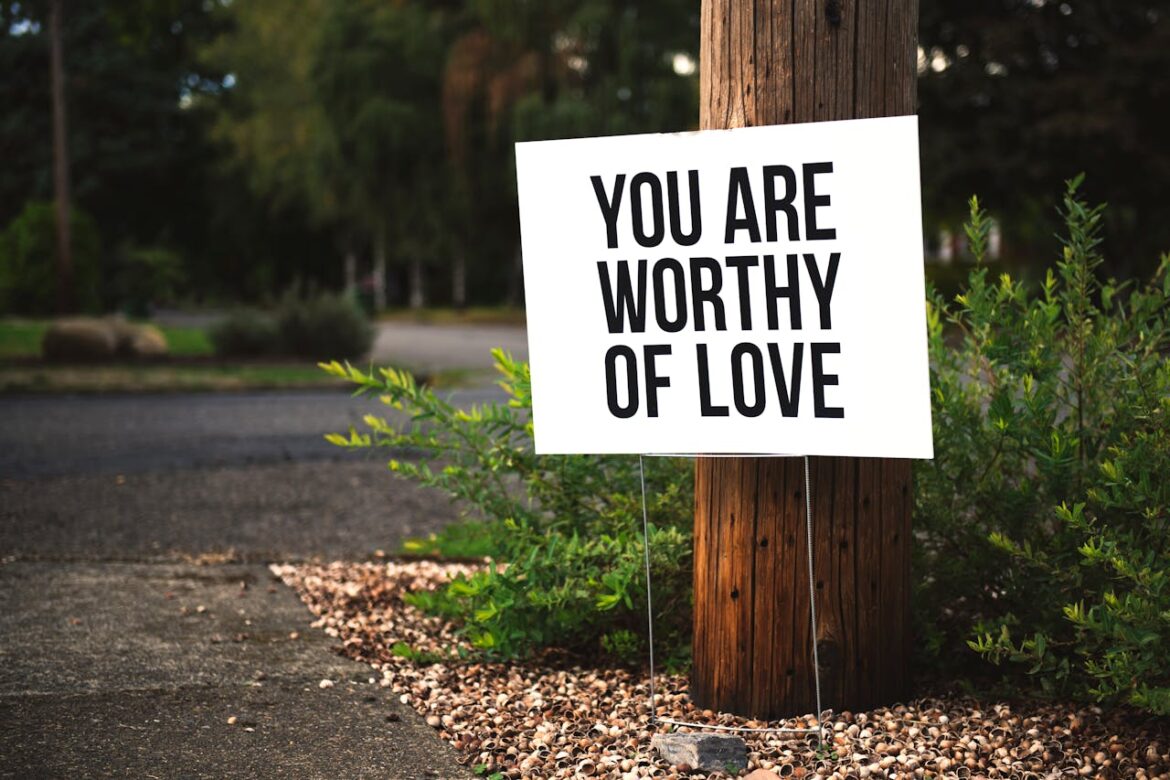 Positive affirmations for recovering addicts written on a sign on the side of the road.
