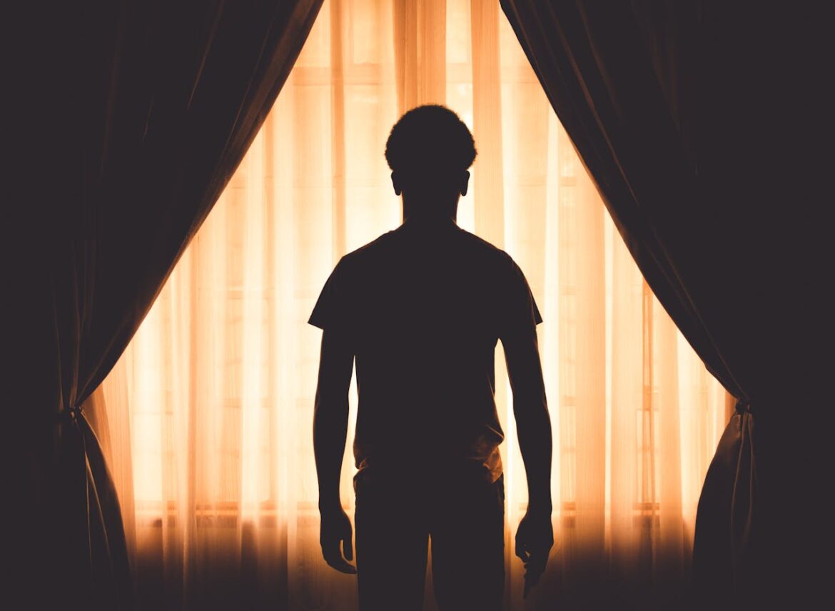 Man standing in front of a window.