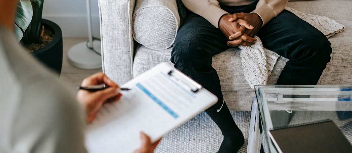 Woman writing in a clipboard while talking to a patient about Concerta withdrawal.