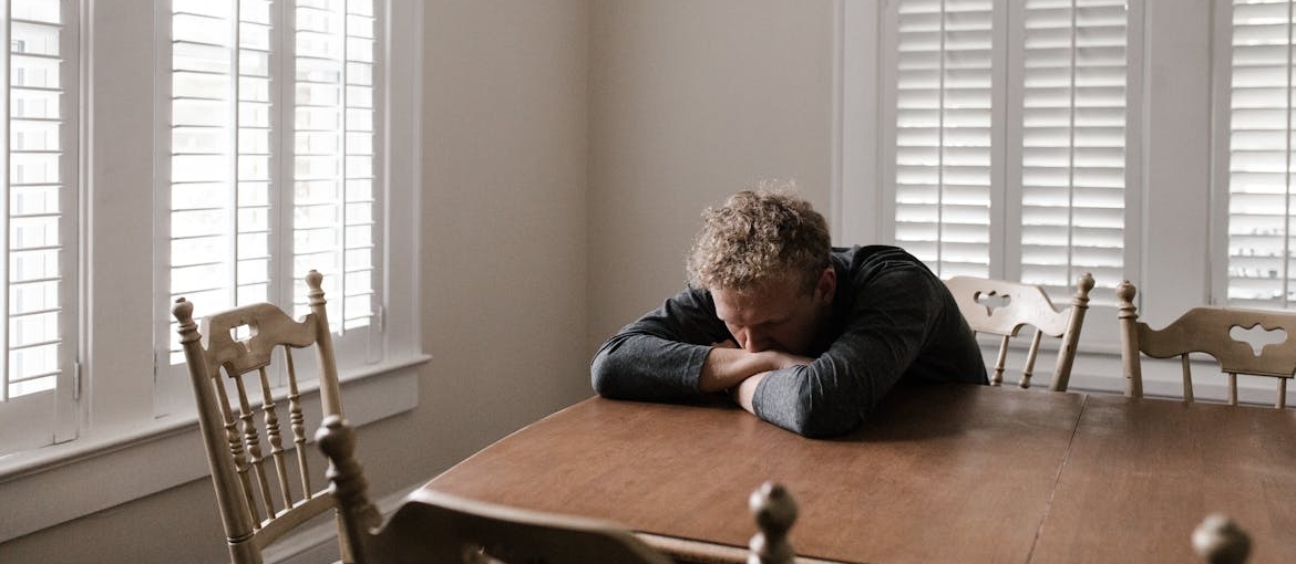 Man experiencing depression during alcohol detox at home.