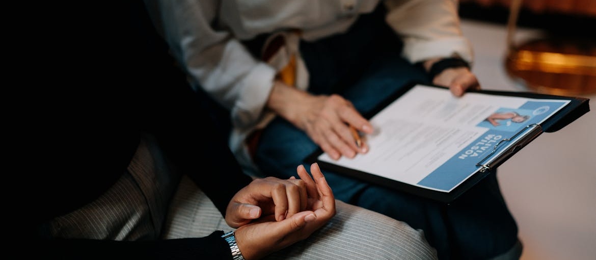 Woman showing her CV to an employer.